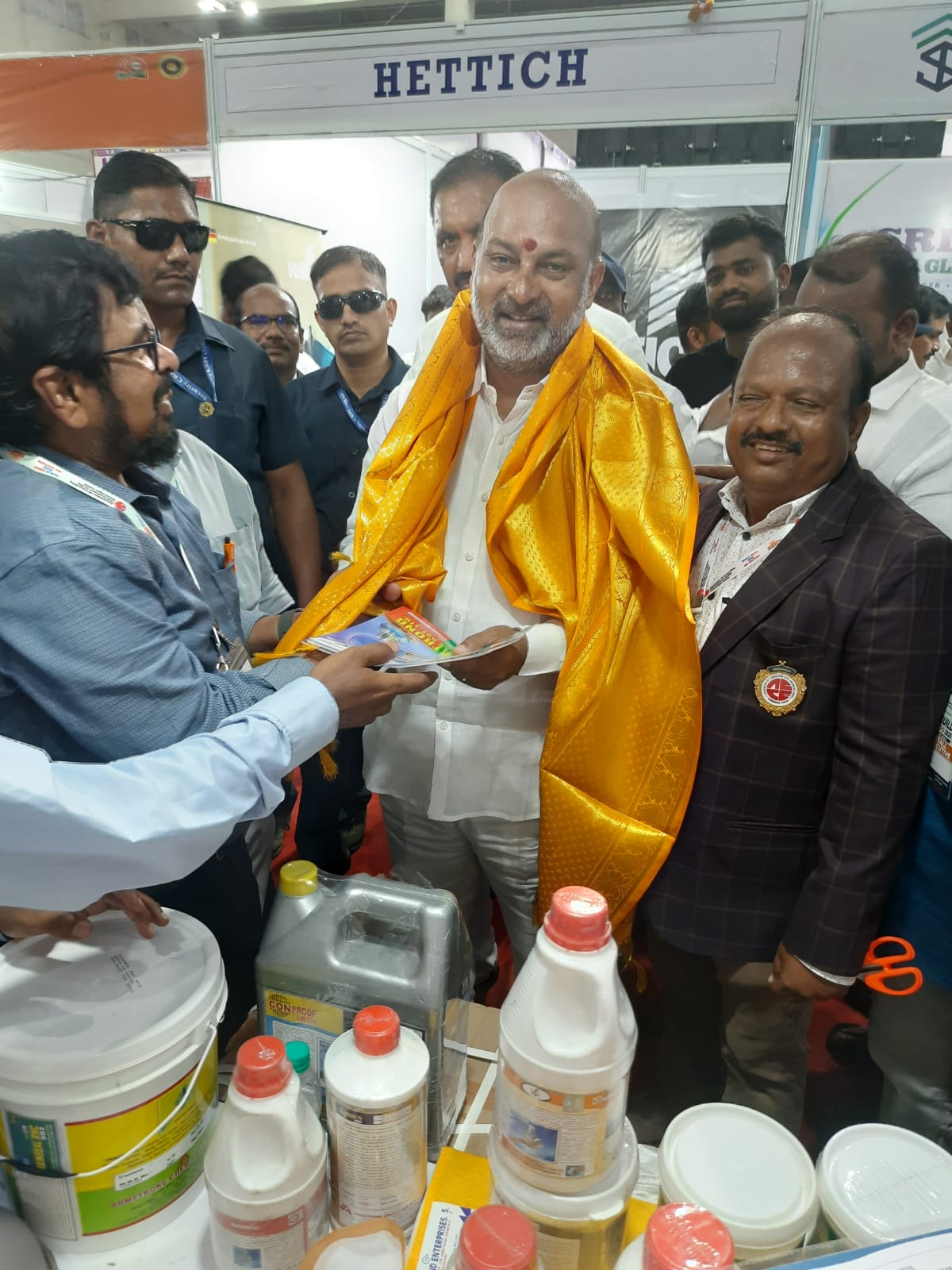 A guest being felicitated with a golden shawl at the Armstrong stall in Karimnagar